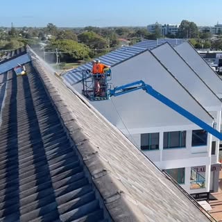Roof spraying in progress on a tiled roof restoration