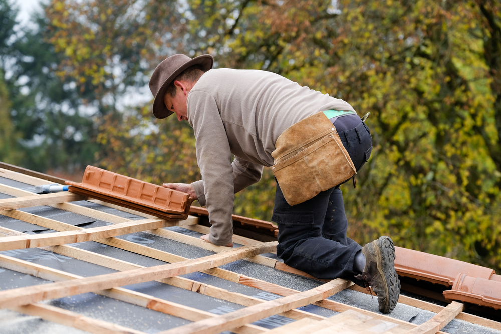 Roof repair work on a Hope Island tile roof